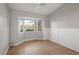 Bedroom with parquet floors, a bay window, and white wall paneling at 33624 Dolores Ct, Leesburg, FL 34788