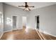 Bright bedroom features parquet floors, light walls, and a ceiling fan at 33624 Dolores Ct, Leesburg, FL 34788