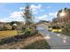 Charming home featuring a red roof, mature landscaping, and a welcoming two-car garage at 33624 Dolores Ct, Leesburg, FL 34788