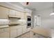 Kitchen features white cabinets, stainless steel appliances, and tile floors at 33624 Dolores Ct, Leesburg, FL 34788