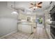 Bright kitchen with neutral countertops, tile floors, and access to the backyard at 33624 Dolores Ct, Leesburg, FL 34788