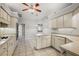 Eat-in kitchen features tile floors, white cabinets, and stainless steel appliances at 33624 Dolores Ct, Leesburg, FL 34788