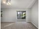 Bright living room with plush carpet and sliding doors leading to outdoor living space at 33624 Dolores Ct, Leesburg, FL 34788