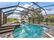A screened-in pool featuring a connected hot tub and brick tiling at 33624 Dolores Ct, Leesburg, FL 34788