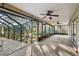 The home's screened-in porch features multiple ceiling fans and views of the yard at 33624 Dolores Ct, Leesburg, FL 34788