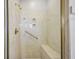 Shower features a built in bench, golden fixtures, and a marble design at 33624 Dolores Ct, Leesburg, FL 34788