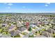 Wide aerial shot showcases the home's location in an extensive suburban neighborhood near a lake at 3373 Melbourne Ln, The Villages, FL 32163