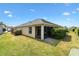 A side-rear view of this home shows the screened in lanai and lush green backyard at 3373 Melbourne Ln, The Villages, FL 32163