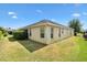 Backyard featuring well-maintained landscaping and partial view of the home's rear exterior at 3373 Melbourne Ln, The Villages, FL 32163