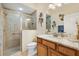 Well-lit bathroom featuring a glass shower, granite countertop, and stylish floral decorations at 3373 Melbourne Ln, The Villages, FL 32163