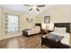 Bright bedroom with two beds, wood-look floors, and ample natural light from a large window at 3373 Melbourne Ln, The Villages, FL 32163