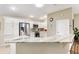 Modern kitchen featuring white cabinets, granite countertops, stainless steel appliances, and ample counter space at 3373 Melbourne Ln, The Villages, FL 32163