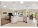 Kitchen with stainless steel appliances, granite countertops, and dining area at 3373 Melbourne Ln, The Villages, FL 32163