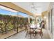 Inviting lanai with a dining table, chairs, and serene views of landscaped backyard at 3373 Melbourne Ln, The Villages, FL 32163