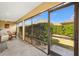 Screened lanai featuring a ceiling fan, dining furniture, and access to a well-manicured yard at 3373 Melbourne Ln, The Villages, FL 32163