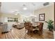 Open concept living and dining area featuring wood floors, comfortable seating, and natural light at 3373 Melbourne Ln, The Villages, FL 32163