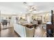 Inviting open-concept living space with wood floors, comfortable seating, and a seamless flow to the kitchen at 3373 Melbourne Ln, The Villages, FL 32163