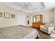 Spacious main bedroom featuring tray ceiling, hardwood floors, and an ensuite bathroom at 3373 Melbourne Ln, The Villages, FL 32163