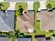 Aerial view of a well-maintained home with a brown roof, green lawn, and a pergola patio at 3405 Rabbit Run Path, The Villages, FL 32163