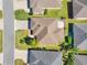 Aerial view of a property featuring a brown roof, manicured lawn, and a brick patio at 3405 Rabbit Run Path, The Villages, FL 32163