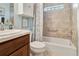 Cozy bathroom with tiled shower, decorative curtain, and natural wood vanity at 3405 Rabbit Run Path, The Villages, FL 32163