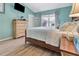 Charming bedroom features stylish wood-look floors, blue walls, and a comfy bed at 3405 Rabbit Run Path, The Villages, FL 32163