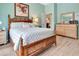 Spacious bedroom with stylish wood-look floors, blue walls, and a bamboo bed frame at 3405 Rabbit Run Path, The Villages, FL 32163