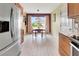 Cozy eat-in kitchen area with ample natural light and wood-look tile flooring at 3405 Rabbit Run Path, The Villages, FL 32163