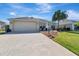 Well-maintained single-story home with a two-car garage and manicured landscaping at 3405 Rabbit Run Path, The Villages, FL 32163