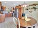 Open-concept kitchen with wood cabinets, stainless steel appliances, and a breakfast nook at 3405 Rabbit Run Path, The Villages, FL 32163