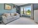 Comfortable living room with neutral carpet, blue walls and bright natural light at 3405 Rabbit Run Path, The Villages, FL 32163