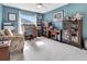 Cozy office with neutral carpet, large window, desk, cabinets, and accent chair at 3405 Rabbit Run Path, The Villages, FL 32163