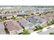 An aerial shot of a residential area with houses with dark roofs and lush green lawns on a sunny day at 345 Alcove Dr, Groveland, FL 34736