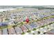 Aerial view of a residential neighborhood near a lake, with many homes and a pin marking a property at 345 Alcove Dr, Groveland, FL 34736