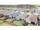 Aerial view of well-maintained homes with green lawns and privacy fences in a quiet neighborhood setting at 345 Alcove Dr, Groveland, FL 34736