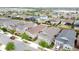 An aerial view showcases homes with mature trees, solar panels, and well-maintained lawns in a vibrant community at 345 Alcove Dr, Groveland, FL 34736