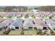 A high angle shot of beautiful homes and landscaped yards surrounded by trees and privacy fences at 345 Alcove Dr, Groveland, FL 34736