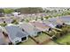 A high-angle shot of homes with manicured lawns and fences in a Gathering-friendly suburban neighborhood at 345 Alcove Dr, Groveland, FL 34736