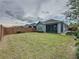 A fully fenced-in backyard with lush green grass and trees, providing a private outdoor space at 345 Alcove Dr, Groveland, FL 34736