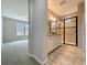 Bathroom featuring a double vanity with granite countertop and a walk-in shower with glass door at 345 Alcove Dr, Groveland, FL 34736
