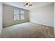 Bright bedroom featuring natural light from two windows and neutral-toned carpeting at 345 Alcove Dr, Groveland, FL 34736