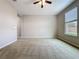 Spacious bedroom featuring carpeted floors, a ceiling fan, and bright natural light at 345 Alcove Dr, Groveland, FL 34736