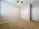 This bedroom has neutral walls, ceiling fan, carpet flooring, and a closet at 345 Alcove Dr, Groveland, FL 34736