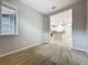 Cozy bedroom with carpet flooring and a view into the adjacent kitchen area at 345 Alcove Dr, Groveland, FL 34736