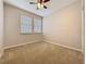 Bright bedroom with carpeted floors, two windows, and a ceiling fan at 345 Alcove Dr, Groveland, FL 34736