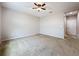 Spacious carpeted bedroom with a ceiling fan and a doorway to another room at 345 Alcove Dr, Groveland, FL 34736
