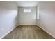 Empty carpeted bedroom with a small window bringing in natural light at 345 Alcove Dr, Groveland, FL 34736
