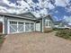 Charming single-Gathering home boasting a brick driveway and stylish garage doors at 345 Alcove Dr, Groveland, FL 34736