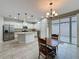 Eat-in kitchen featuring white cabinets, granite countertops, stainless steel appliances, and tile flooring at 345 Alcove Dr, Groveland, FL 34736