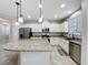 Kitchen featuring white cabinets, granite countertops, stainless steel appliances, recessed lights, and a large island at 345 Alcove Dr, Groveland, FL 34736